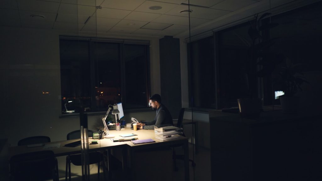 Founder working late alone at a dimly lit desk, illustrating the solo founder lead gen grind