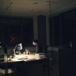 Founder working late alone at a dimly lit desk, illustrating the solo founder lead gen grind
