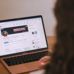 Person reviewing a professional profile on a laptop while evaluating a social selling CRM