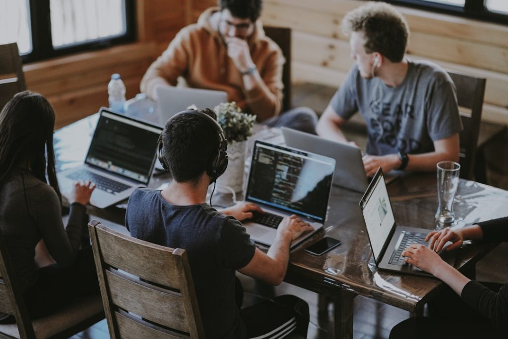 A group of founders and operators working together on laptops, evaluating LinkedIn outreach and Expandi alternatives for their sales pipeline.