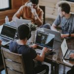 A group of founders and operators working together on laptops, evaluating LinkedIn outreach and Expandi alternatives for their sales pipeline.