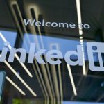 The LinkedIn logo and 'Welcome to LinkedIn' lettering etched on a glass office window, illustrating an article on connecting LinkedIn data to a CRM.