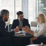 People networking around a table at a business event, illustrating warm leads generated through real engagement
