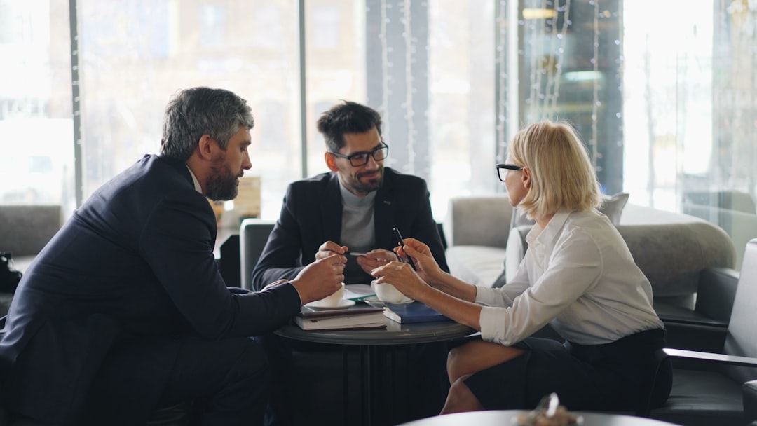 People networking around a table at a business event, illustrating warm leads generated through real engagement