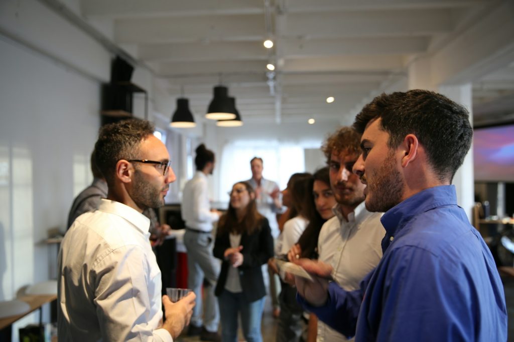 Sales professionals in conversation, illustrating the difference between warm leads and hot leads