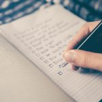 Person writing focused notes - warm outreach strategy for LinkedIn lead generation