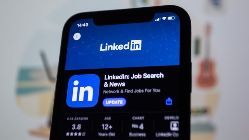 The LinkedIn logo displayed on a smartphone screen, the feed where buyer engagement signals show up.