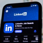 The LinkedIn logo displayed on a smartphone screen, the feed where buyer engagement signals show up.